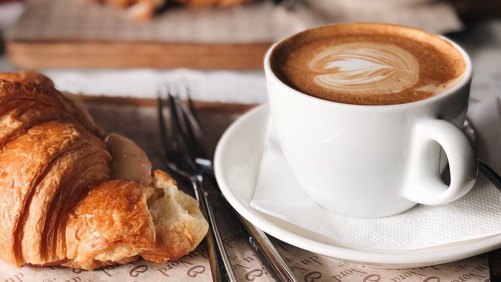 Cappuccino and fresh croissants at a networking breakfast